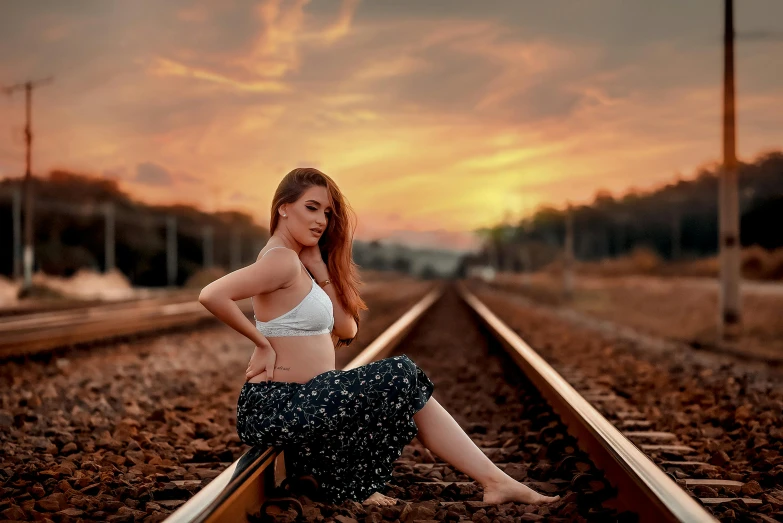 a woman sitting on train tracks at sunset, an album cover, by Marshall Arisman, pexels contest winner, fantastic realism, 2 4 year old female model, today\'s featured photograph 4k, handsome girl, body portrait