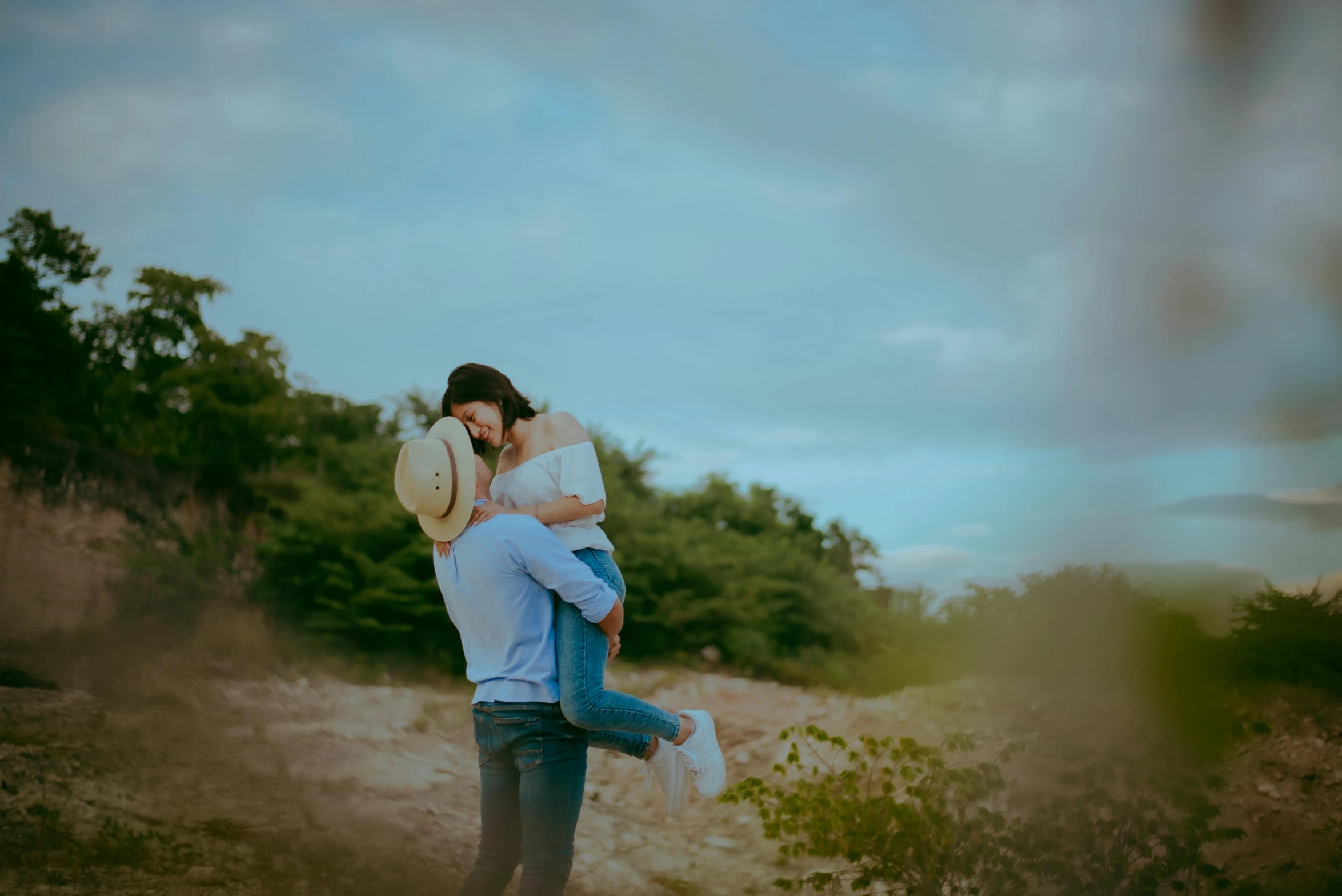 a man hugs a woman on the cheek