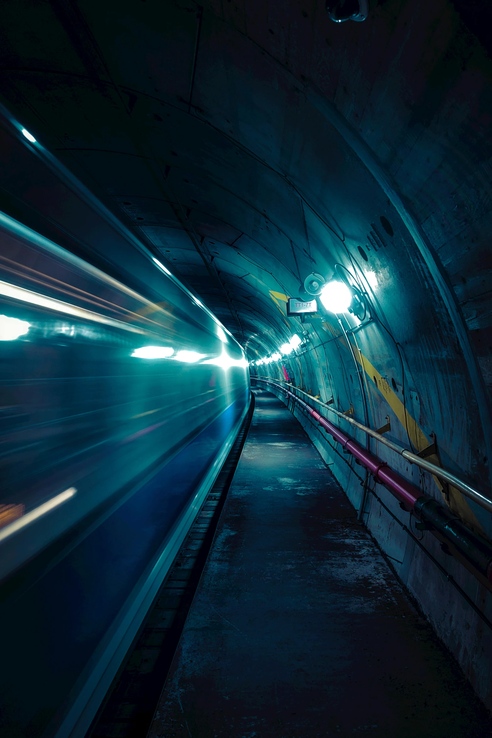 a train traveling through a tunnel at night, unsplash contest winner, in an underground laboratory, warp, navy, speed