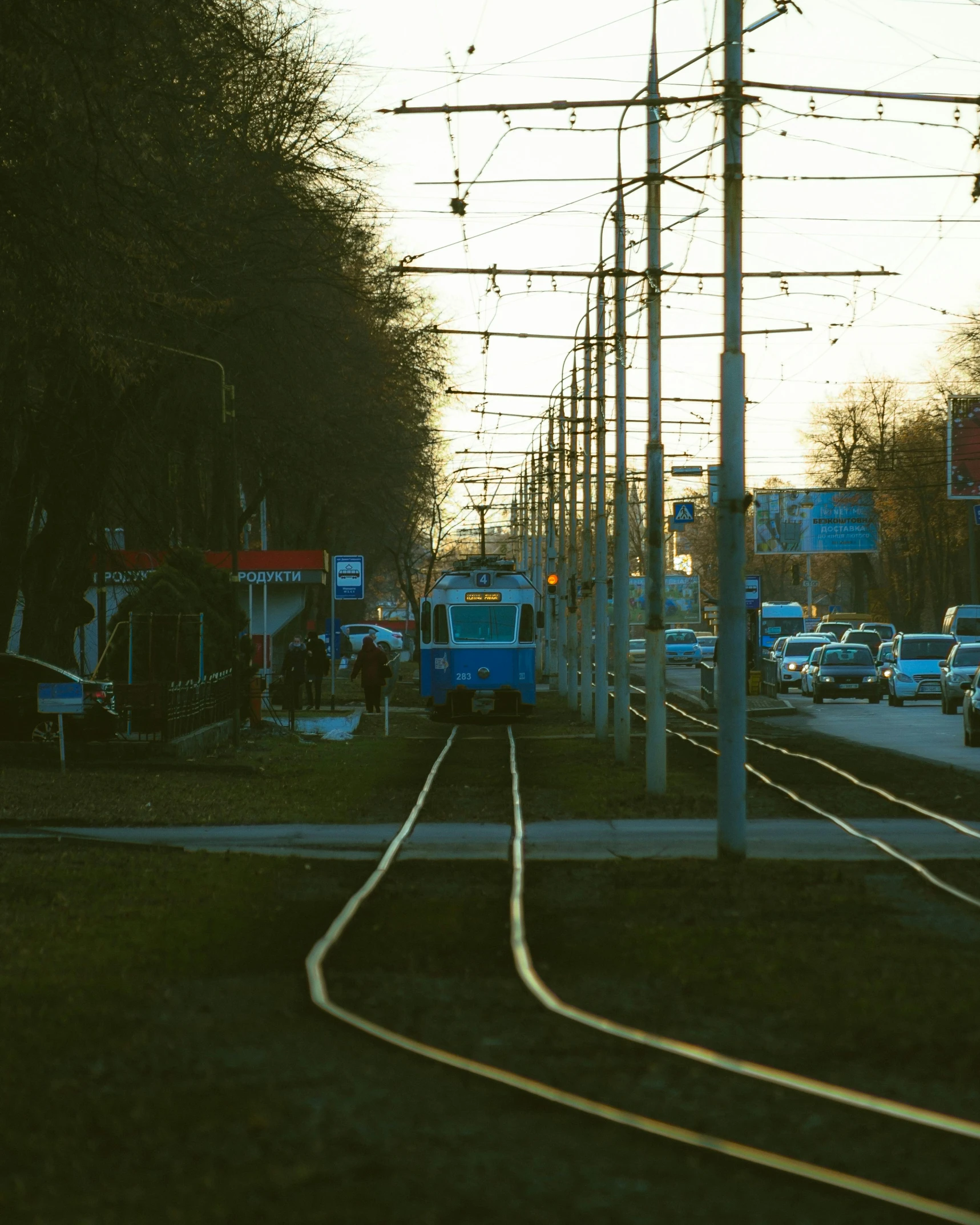 a train track passing through an intersection with grass