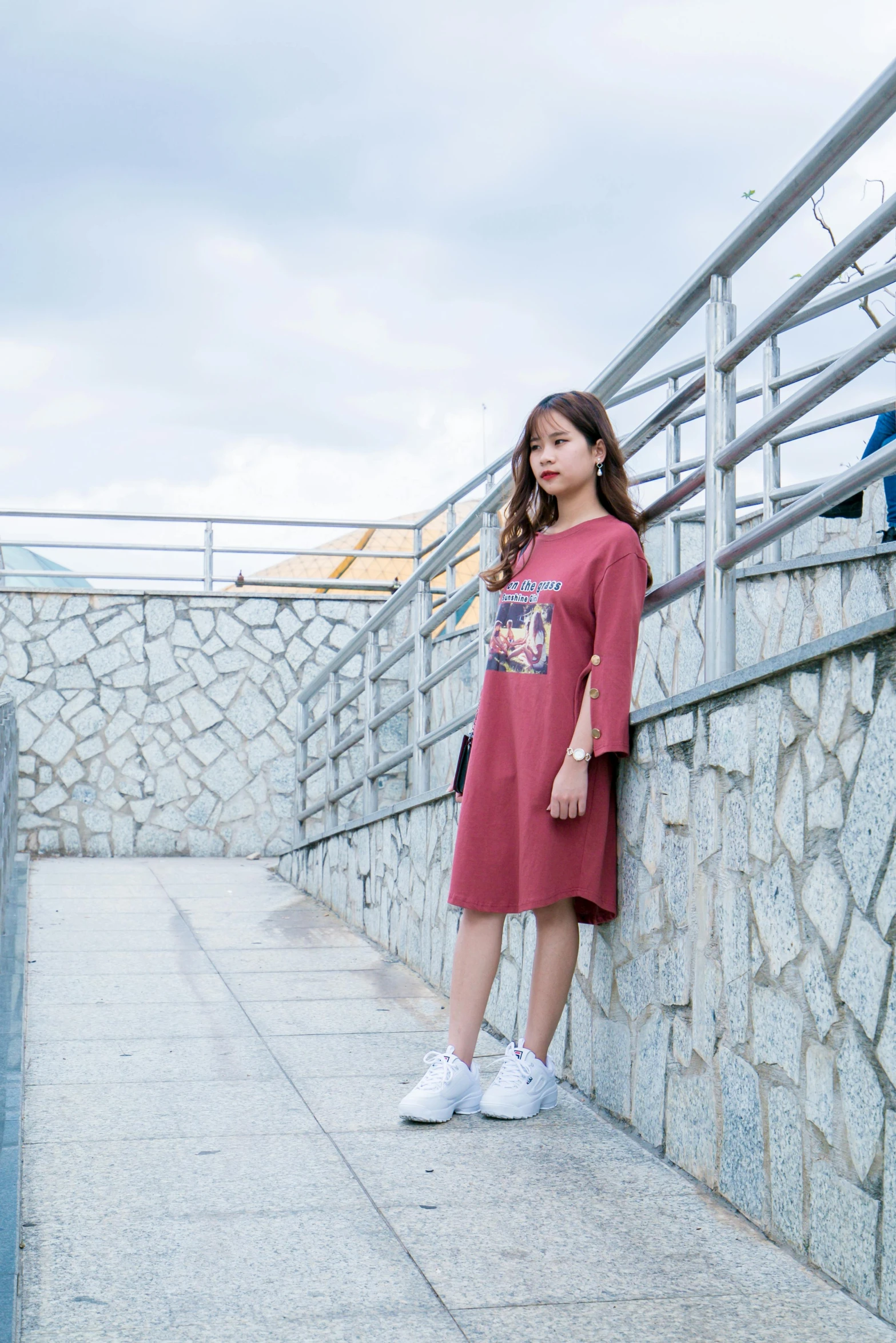 a woman standing in front of a stone wall, a picture, inspired by Ni Yuanlu, pexels contest winner, happening, cute casual streetwear, maroon red, kids, long dress