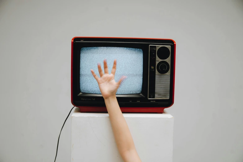 a person reaching up to a television set, pexels, video art, instagram post, 1980s photo, cast, enamel