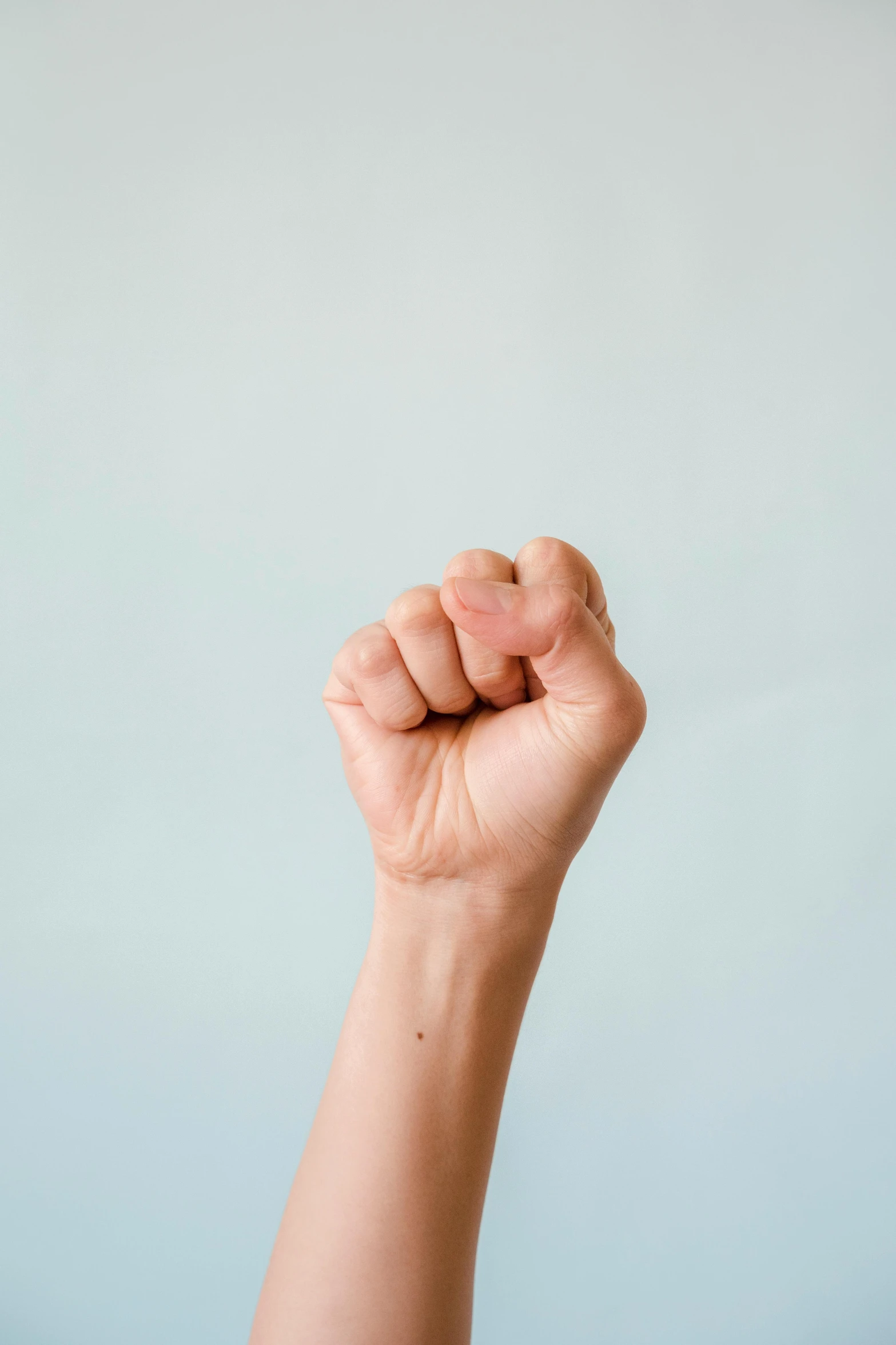 a person holding a cigarette lighter near their left hand