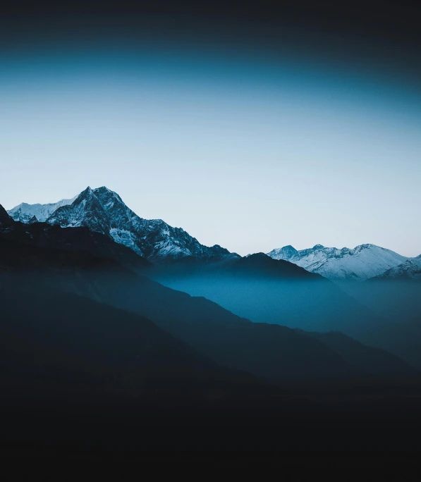 a mountain range with snow capped mountains in the distance, an album cover, by Matthias Weischer, unsplash contest winner, sumatraism, uttarakhand, dark blue mist, hq 4k phone wallpaper, multiple stories