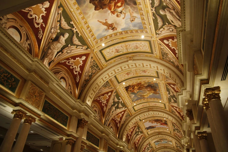 the painted ceiling in a building with columns