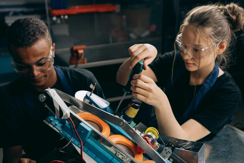 a couple of women standing next to each other, by Lee Loughridge, pexels contest winner, renaissance, handling laboratory equipment, repairing the other one, teenage engineering moad, with electric arc devices