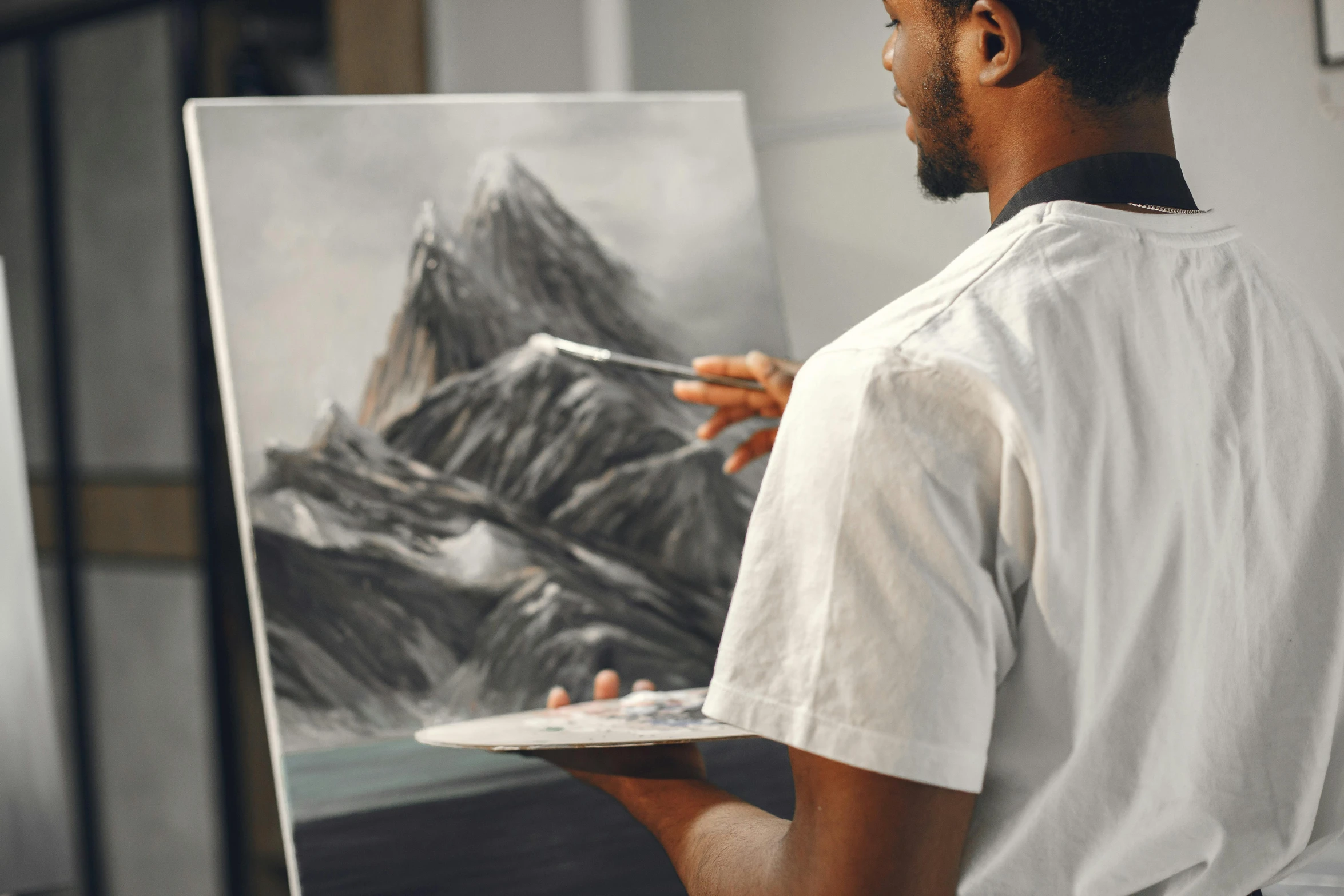 a man that is standing in front of a painting, inspired by Bob Ross, pexels contest winner, academic art, a painting of white silver, painting a canvas, charcoal painting, on a canva