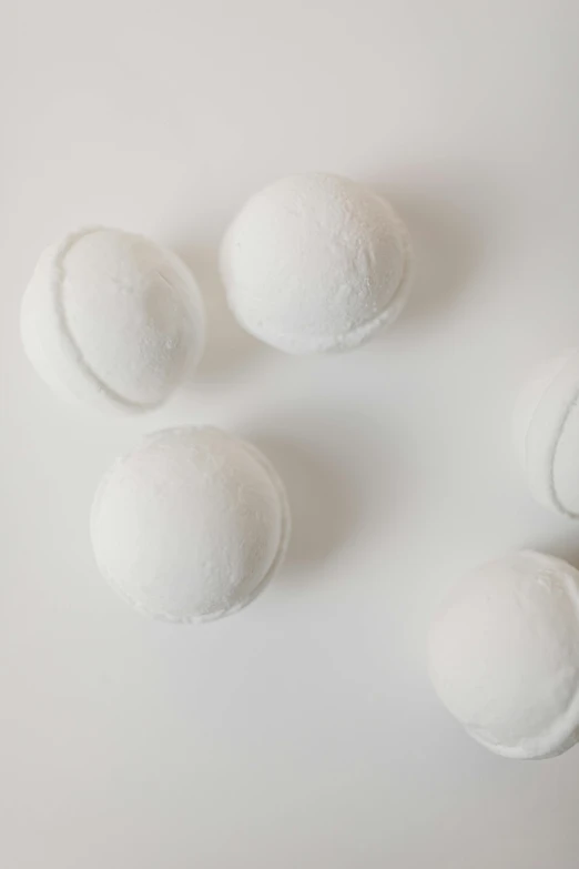 four white bath bombs on a white surface, thumbnail, 1 6 x 1 6, incubator medpods, detail shot