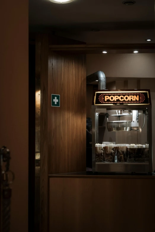 there is a popcorn machine in the dark on the floor
