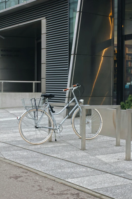 a bicycle is parked in front of a building, stanchions, shiny silver, arasaka, rectangle