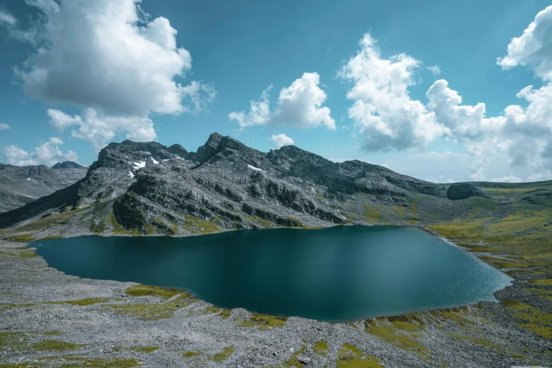 large body of water near mountain ridge during daytime