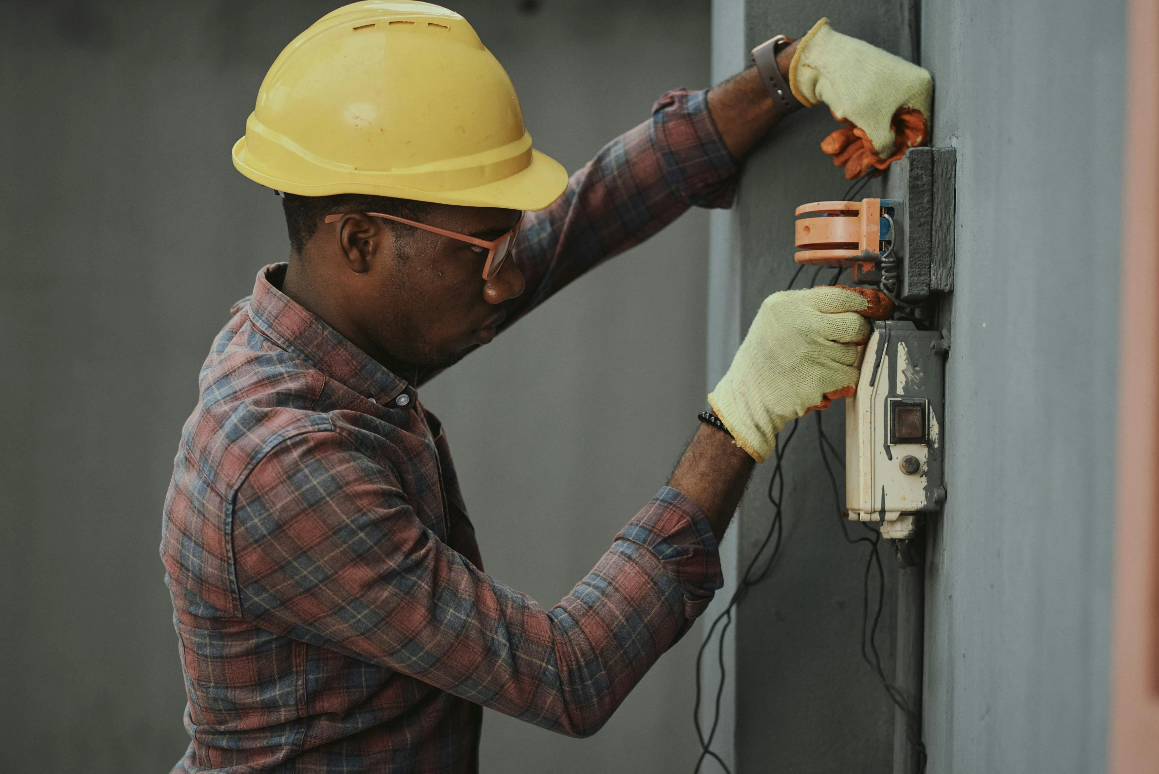 a man in a hard hat working on an electrical panel, pexels contest winner, renaissance, african american, thumbnail, - 6, grey