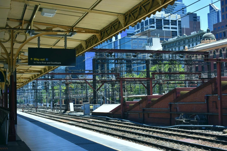 a train station that is empty with many train tracks