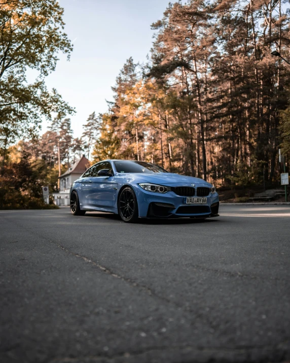 a bmw is driving on a street in the sun