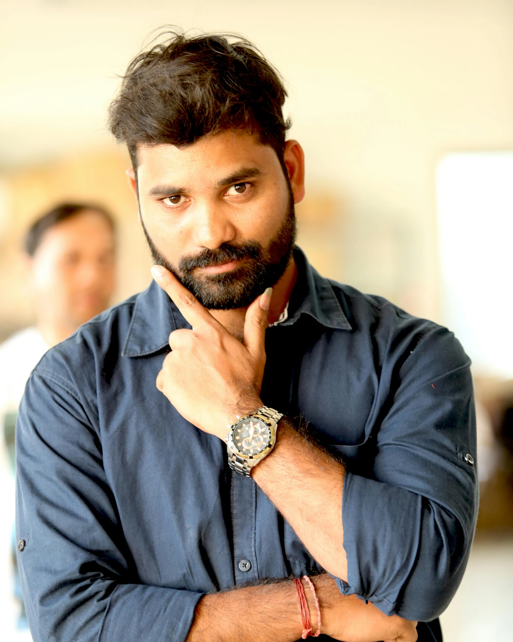 man with wrist watch posing for camera near other men