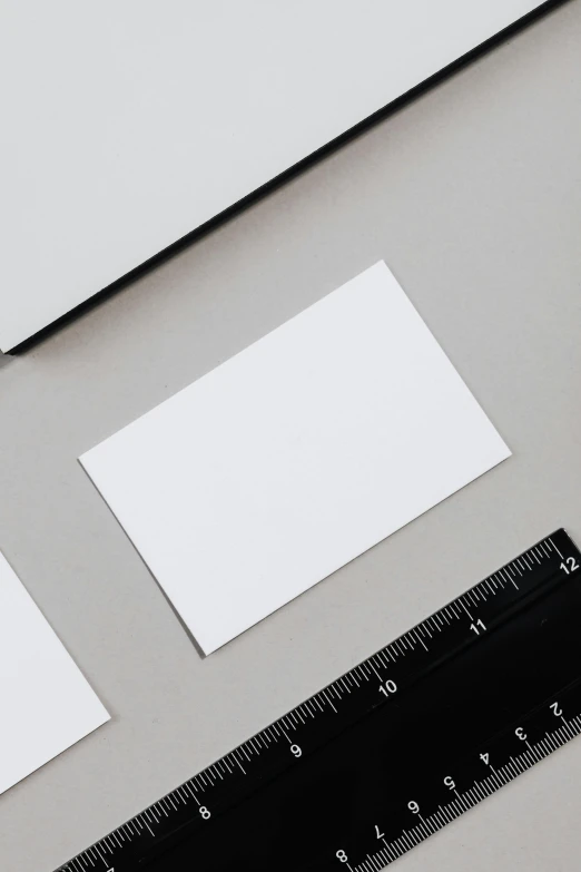 an open laptop computer sitting on top of a desk next to a ruler, a picture, by Harvey Quaytman, unsplash, card back template, square sticker, 9 0 mm studio photograph tiny, white metallic