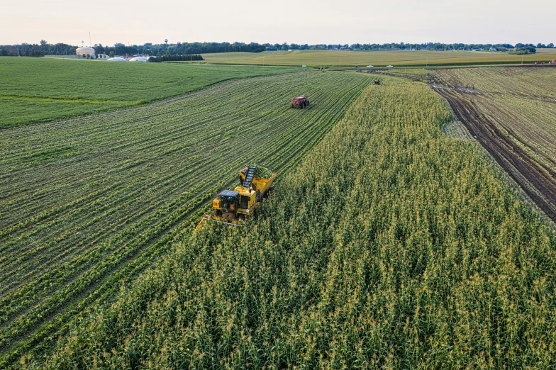 a farm in the middle of a large green field