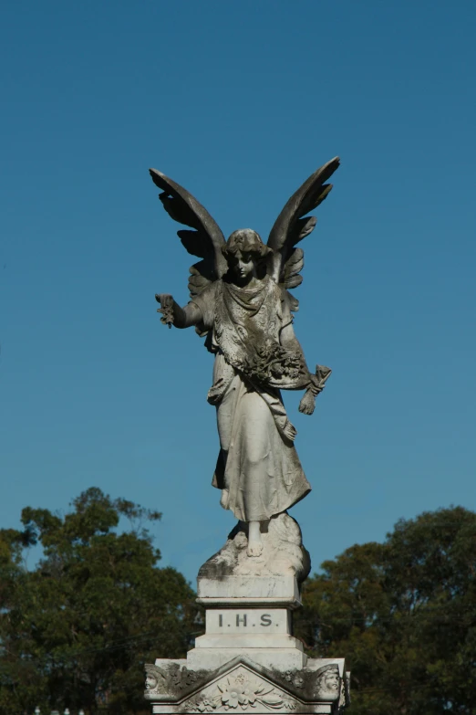 a statue of an angel in a cemetery, inspired by Edwin Deakin, straya, a long-shot from front, skies
