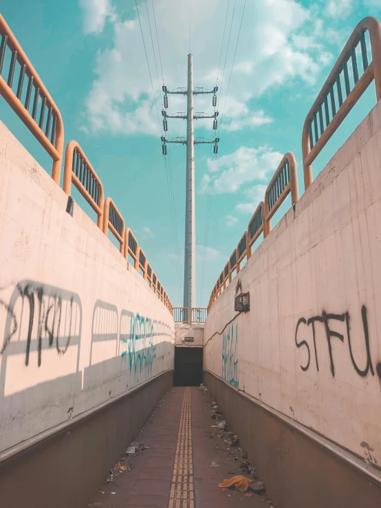 a bridge that has graffiti on the side of it, an album cover, inspired by Elsa Bleda, unsplash, graffiti, snapchat photo, two stories, leading to the sky, photo of scp-173