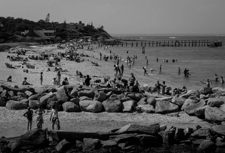 black and white image of people on the beach