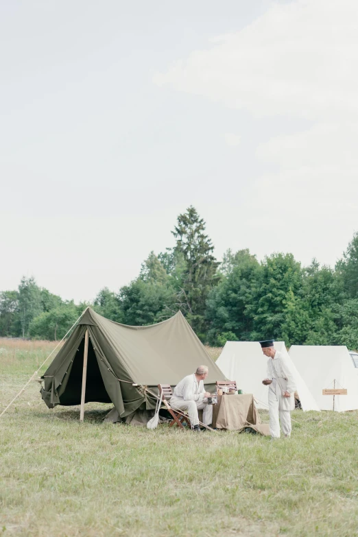 a couple of men standing next to a tent, by Ilya Ostroukhov, unsplash, renaissance, set in ww2 germany, wedding, “wide shot, picnic