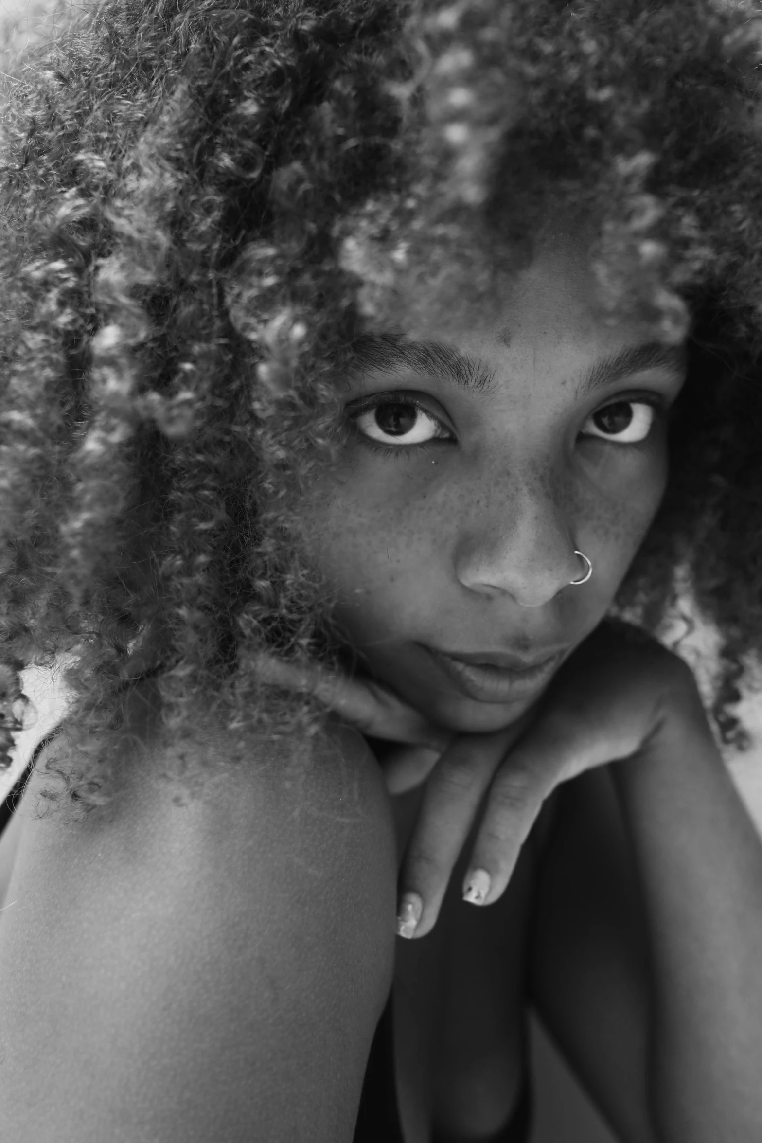 a black and white photo of a woman with curly hair, pexels contest winner, black teenage girl, medium format, high angle closeup portrait, ((portrait))