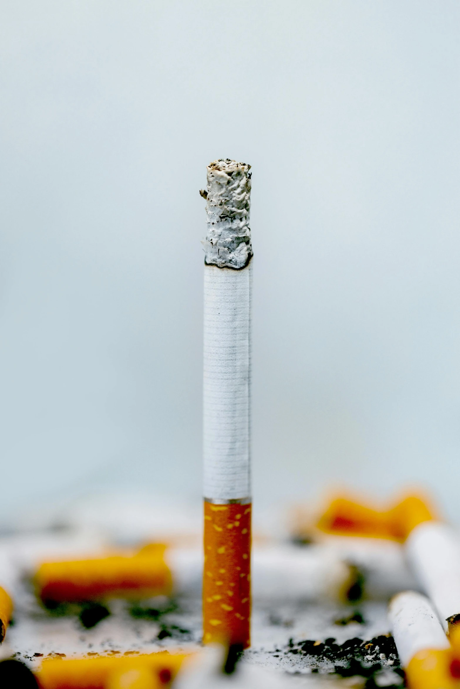 a cigarette with a cigarette stick next to it