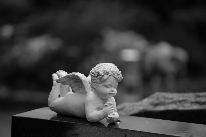 a black and white photo of a statue of an angel, a statue, by Joze Ciuha, figuration libre, cutest, lying, lowres, small stature