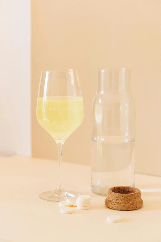 a couple of wine glasses sitting on top of a table, inspired by Évariste Vital Luminais, glass jar, lemonade, sparse detail, eora