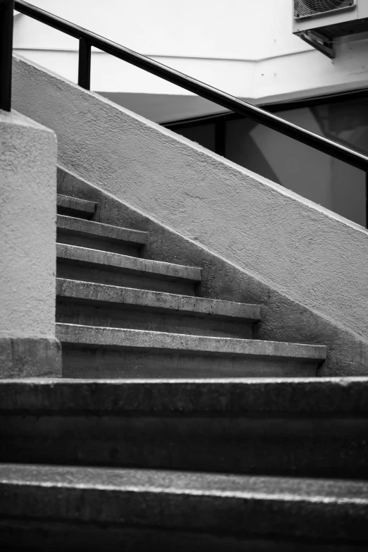 a man riding a skateboard up the side of a flight of stairs, a black and white photo, inspired by Louis Stettner, brutalism, ( ( abstract ) ), made of concrete, hasselblad photograph, leica s photograph