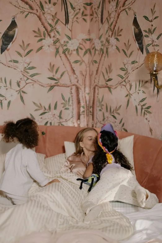 a couple of girls sitting on top of a bed, inspired by Cecil Beaton, trending on pexels, rococo, with a kid, super aesthetic, making out, wall mural