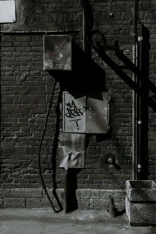 a black and white photo of a fire hydrant, inspired by Roy DeCarava, conceptual art, cyberpunk back alley, attached to wires. dark, ignant, 1990s photograph