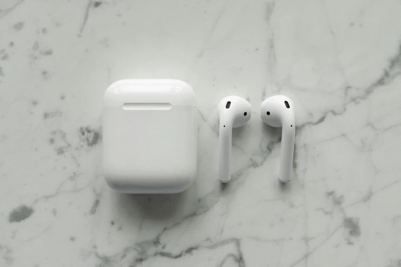 a pair of airpods sitting on top of a marble counter, by Carey Morris, pexels, square, white sleeves, made of glazed, apples