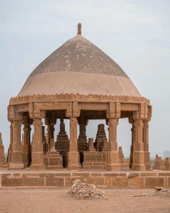 a stone structure sitting in the middle of a desert, a marble sculpture, samikshavad, fan favorite, brown durand, moorish architecture, festival