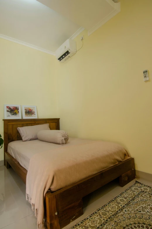 a bedroom with beige walls, a bed and a window