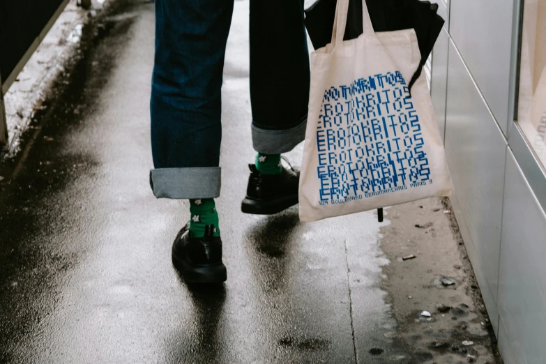 a woman with green socks and a bag in the rain