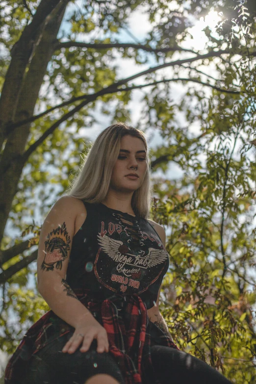 a woman riding on the back of a horse, an album cover, inspired by Elsa Bleda, unsplash, graffiti, alluring plus sized model, against the backdrop of trees, she is wearing a black tank top, punk rock clothes