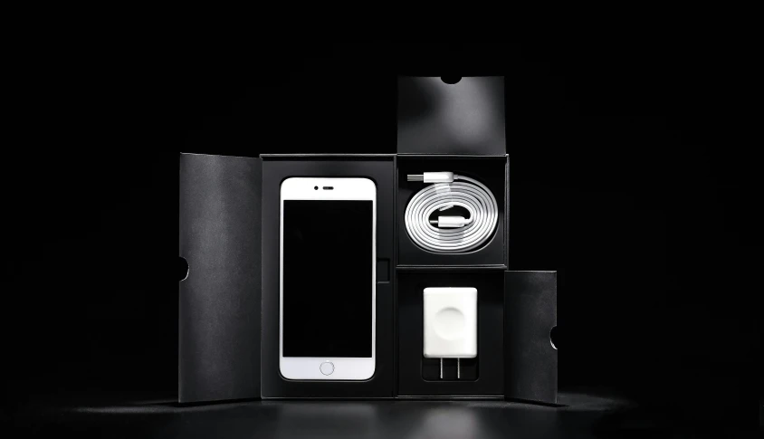 a white cell phone sitting inside of a black box, products shot, exceptional, pack, assembled