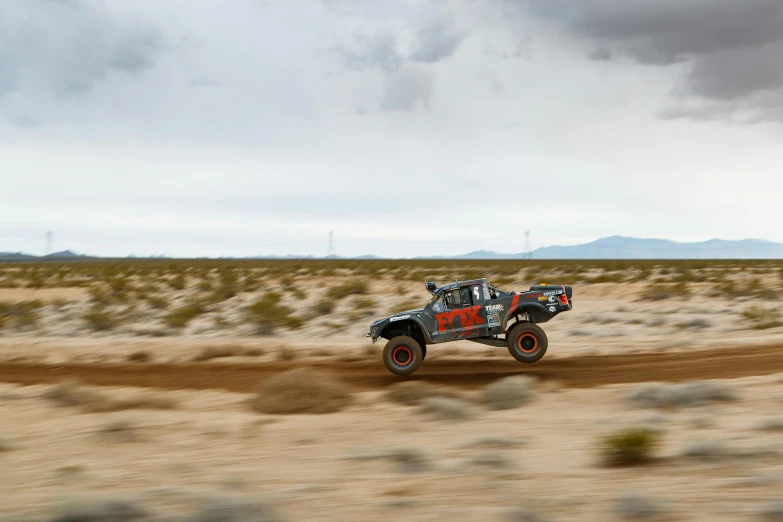 the off road vehicle is going through the sand