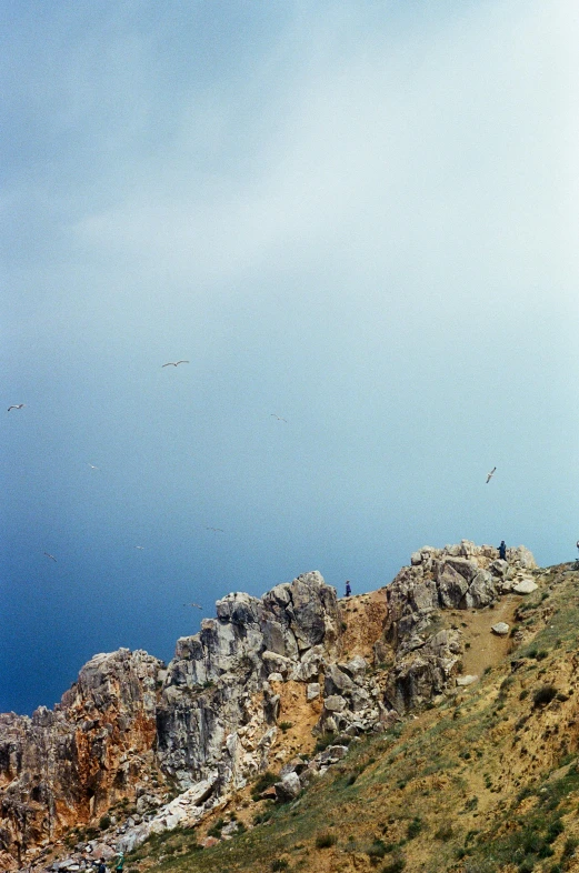 two people walking up a hill to take pictures