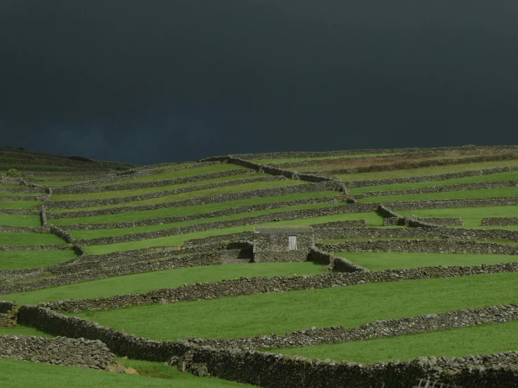 stone farm machinery are lined with green grass