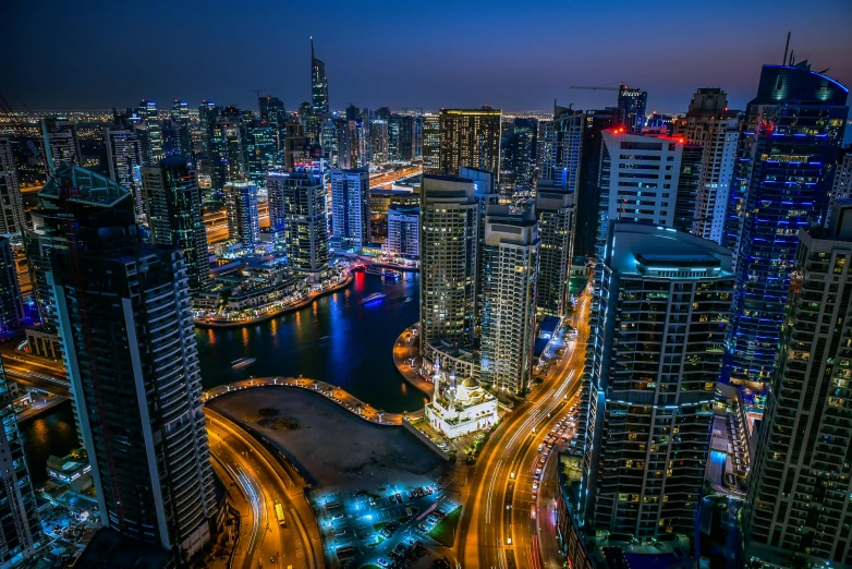 an elevated view of a city and bridge at night