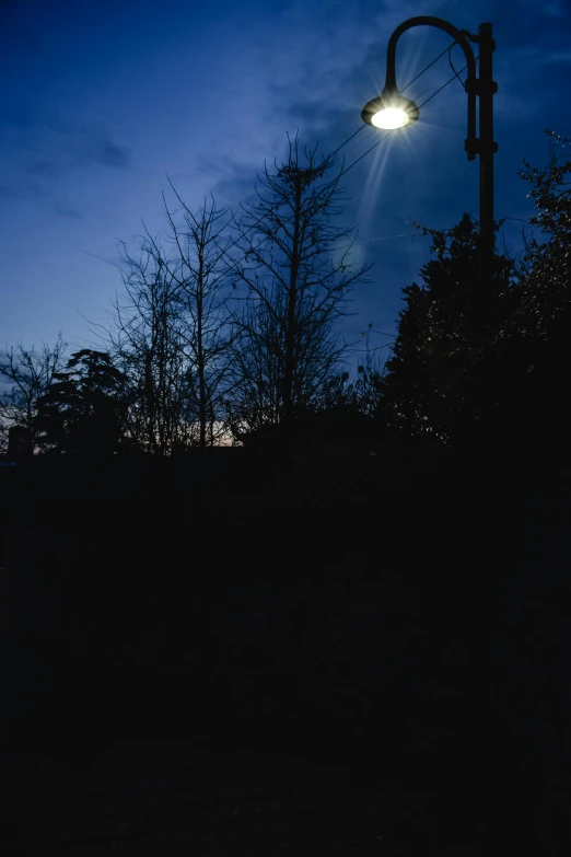 a street light sitting on the side of a road, inspired by Gregory Crewdson, hurufiyya, medium format. soft light, panorama, 35mm —w 1920 —h 1080, back yard