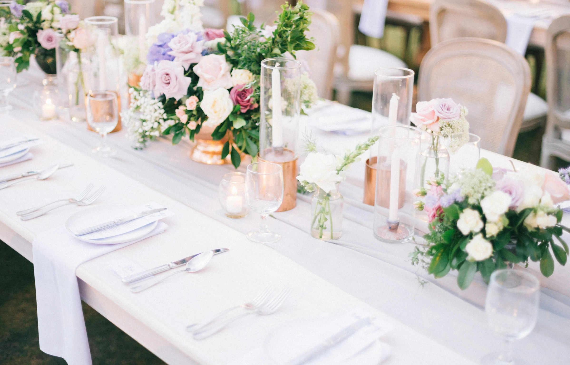 tables and chairs covered with candles, flowers and napkins