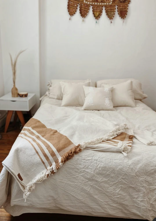 a white bed topped with lots of pillows