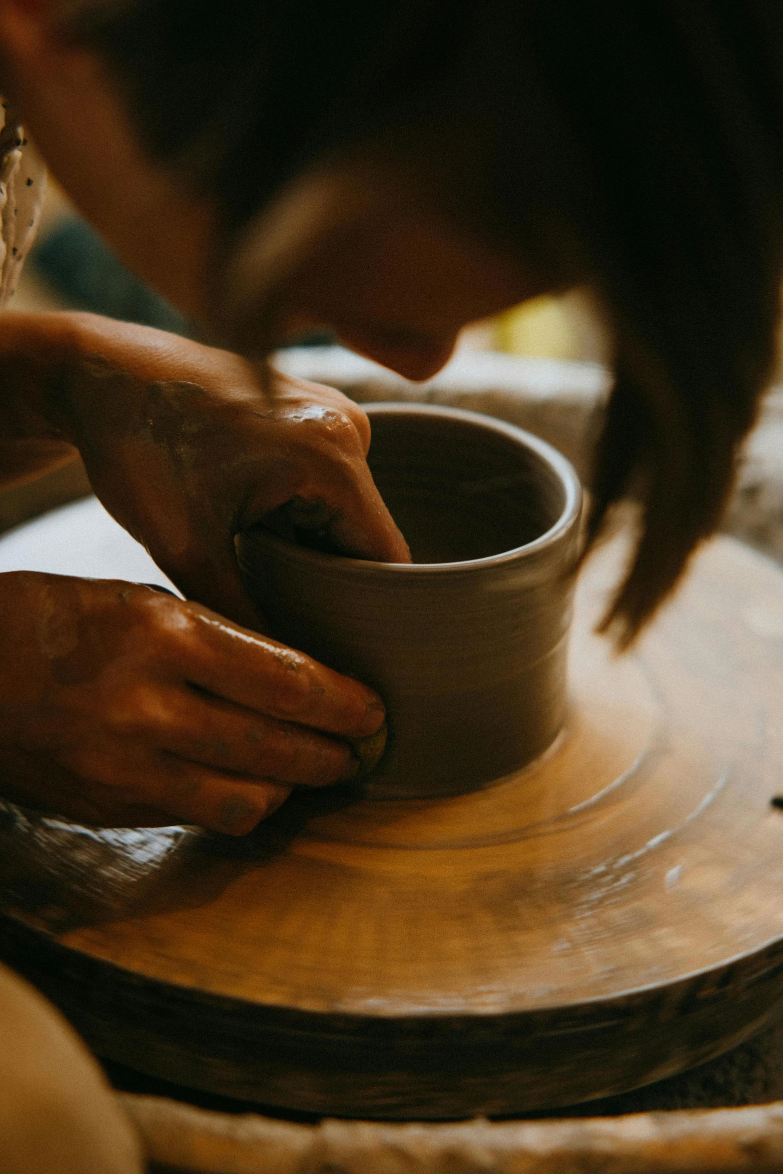 a woman is making a bowl out of clay, inspired by Hendrik Gerritsz Pot, pexels contest winner, instagram story, made of glazed, sydney hanson, laura watson