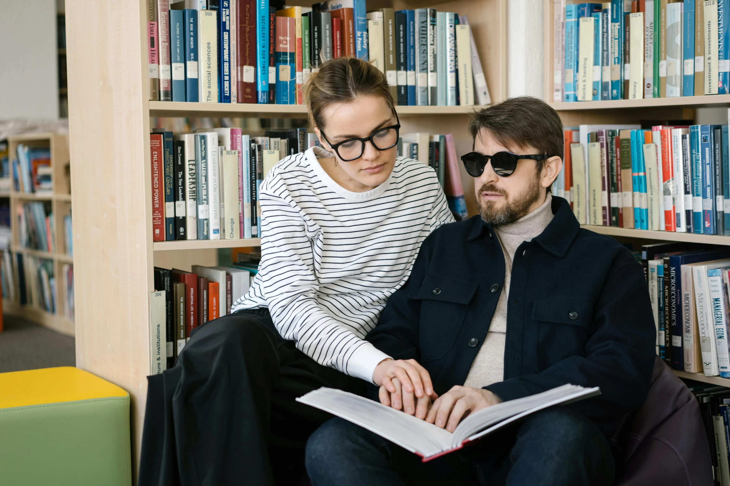 a man and woman reading a book in a library, a portrait, by Zofia Stryjenska, trending on unsplash, with nerdy glasses and goatee, sydney hanson, two buddies sitting in a room, academic clothing