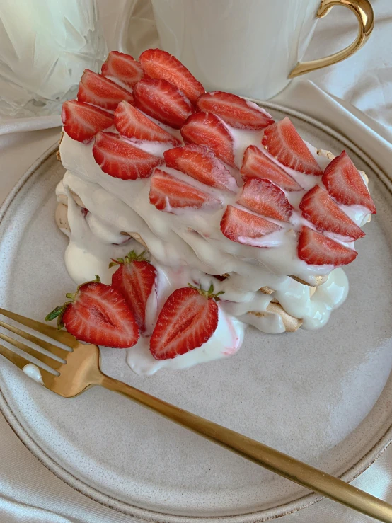 a white plate topped with a piece of cake covered in strawberries, by Valentine Hugo, unsplash, photorealism, taken on iphone 1 3 pro, magnolia, stacked, soft lightening