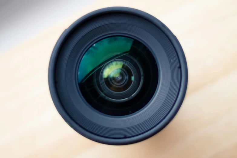 a camera lens sitting on top of a wooden table, by Carey Morris, unsplash, pov camera looking into the maw, hd footage, extremely wide angle, high megapixel picture