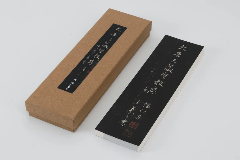 a box that has some writing on it, inspired by Sesshū Tōyō, unsplash, sōsaku hanga, with a black background, 130mm, bo xun ling, in the original box